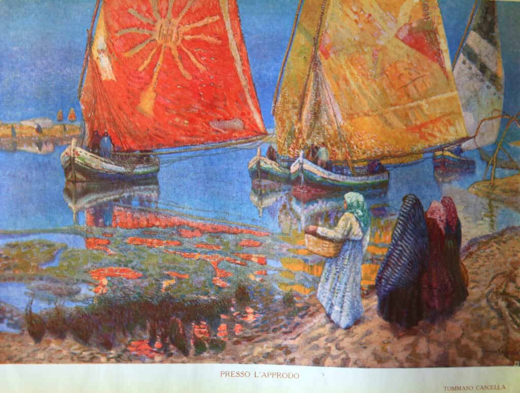 Traditional fishing scene with colourful sails and local fishermen in Abruzzo's coastal town.