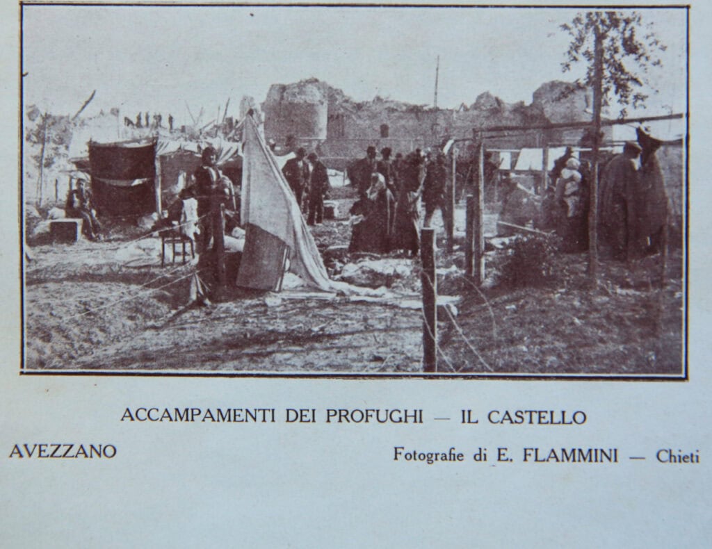 Refugee camp at Avezzano castle in Italy, showing soldiers and tents from the early 20th century.